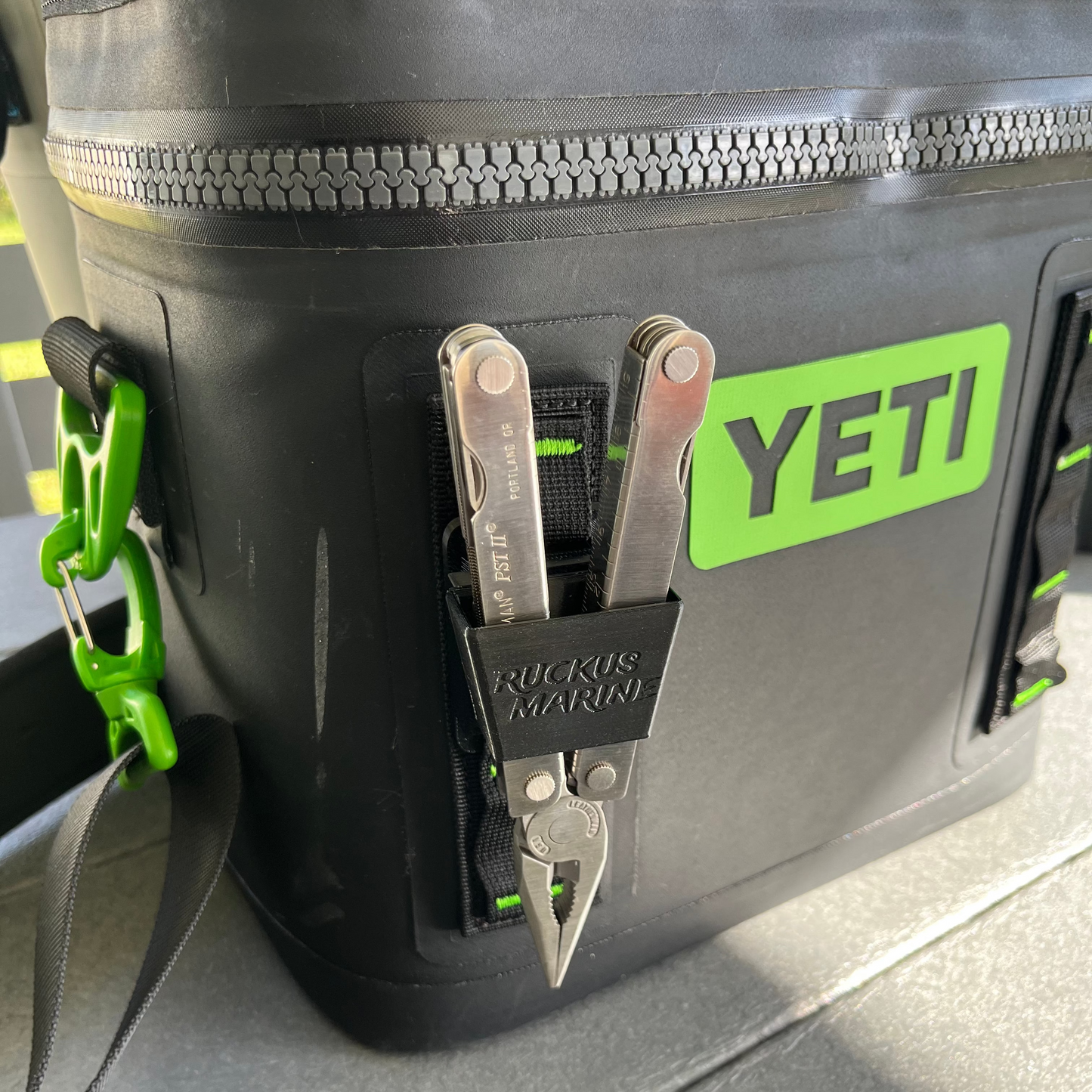 Black Ruckus Marine pliers holder shown on a black Yeti hopper cooler