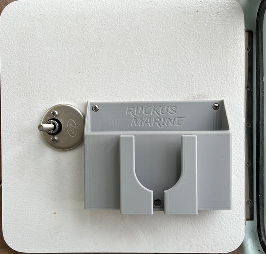 Ruckus Marine Console Caddy mounted on a vertical skiff console door, holding keys, phone, and remote—keeps essentials securely stowed during rough rides