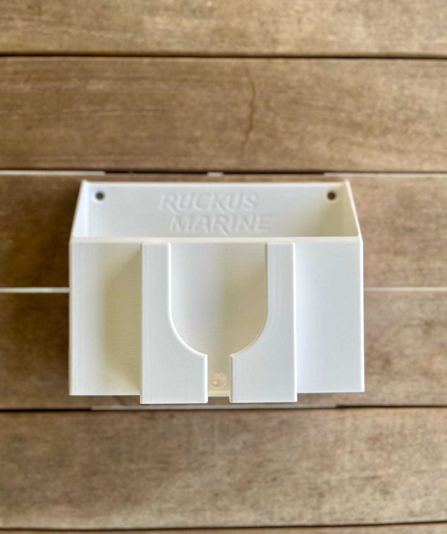 Close-up of Ruckus Marine Console Caddy in white showing built-in phone slot and drain feature for easy rinsing and drying between runs