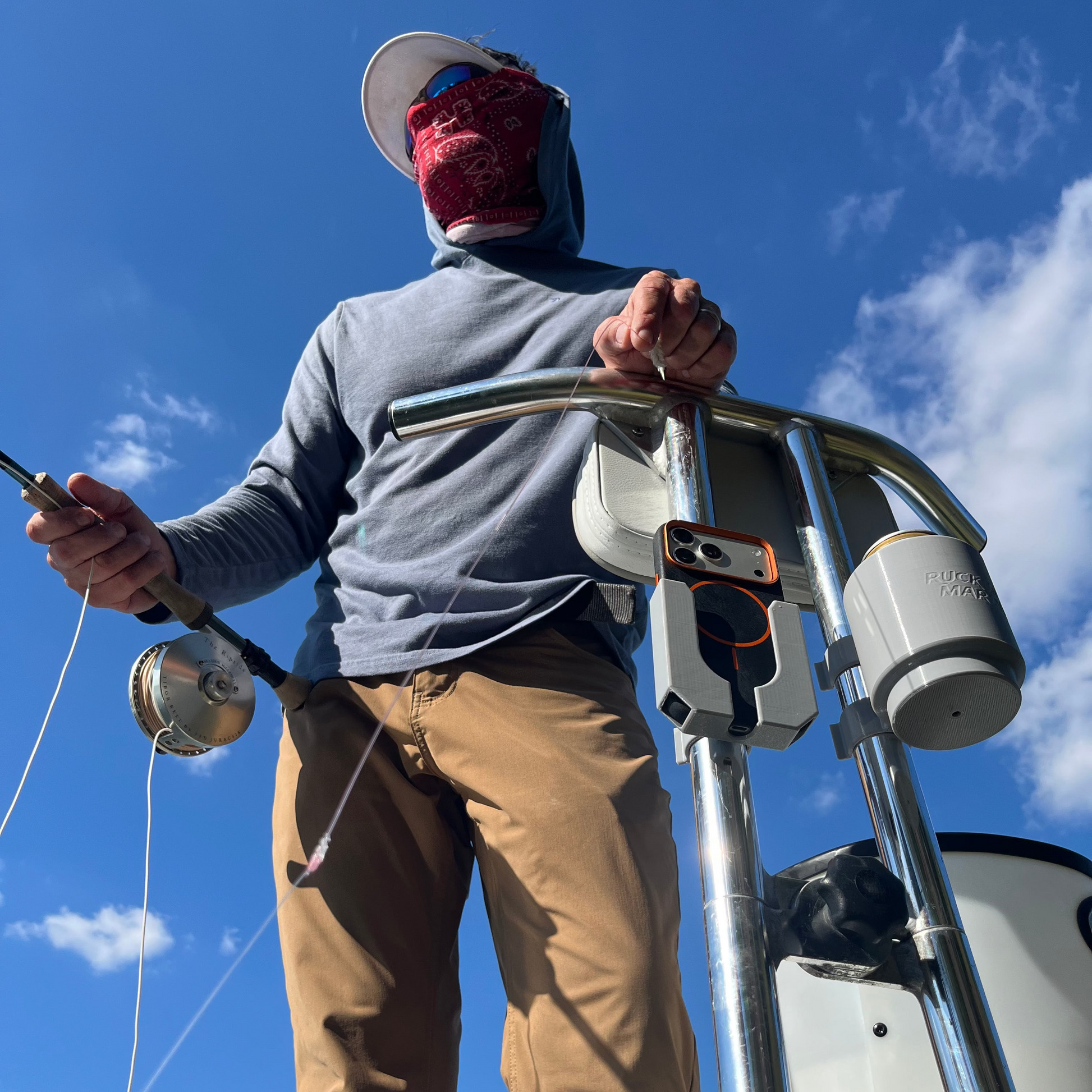 Phone and cup holder sissy bar attachments by Ruckus Marine with a fly fishing angler waiting on fish