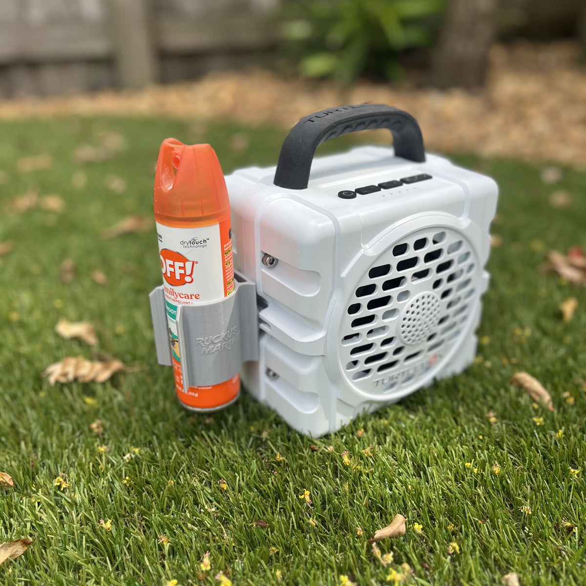 Spray can holder Turtlebox Cub attachment from Ruckus Marine shown in gray holding a bug spray can