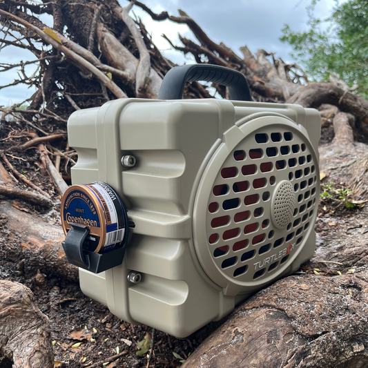 Ruckus Marine Turtlebox Zyn & Dip Can Holder shown in black on roots of fallen oak tree