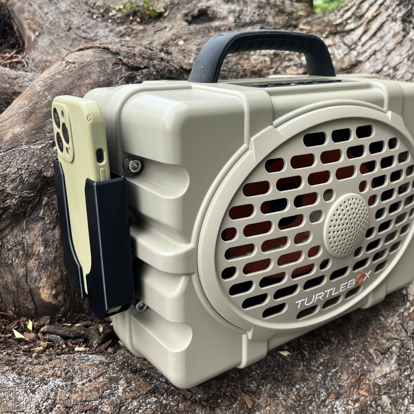Turtlebox Phone Holder attachment from Ruckus Marine shown in black on a tan Turtlebox Gen 3